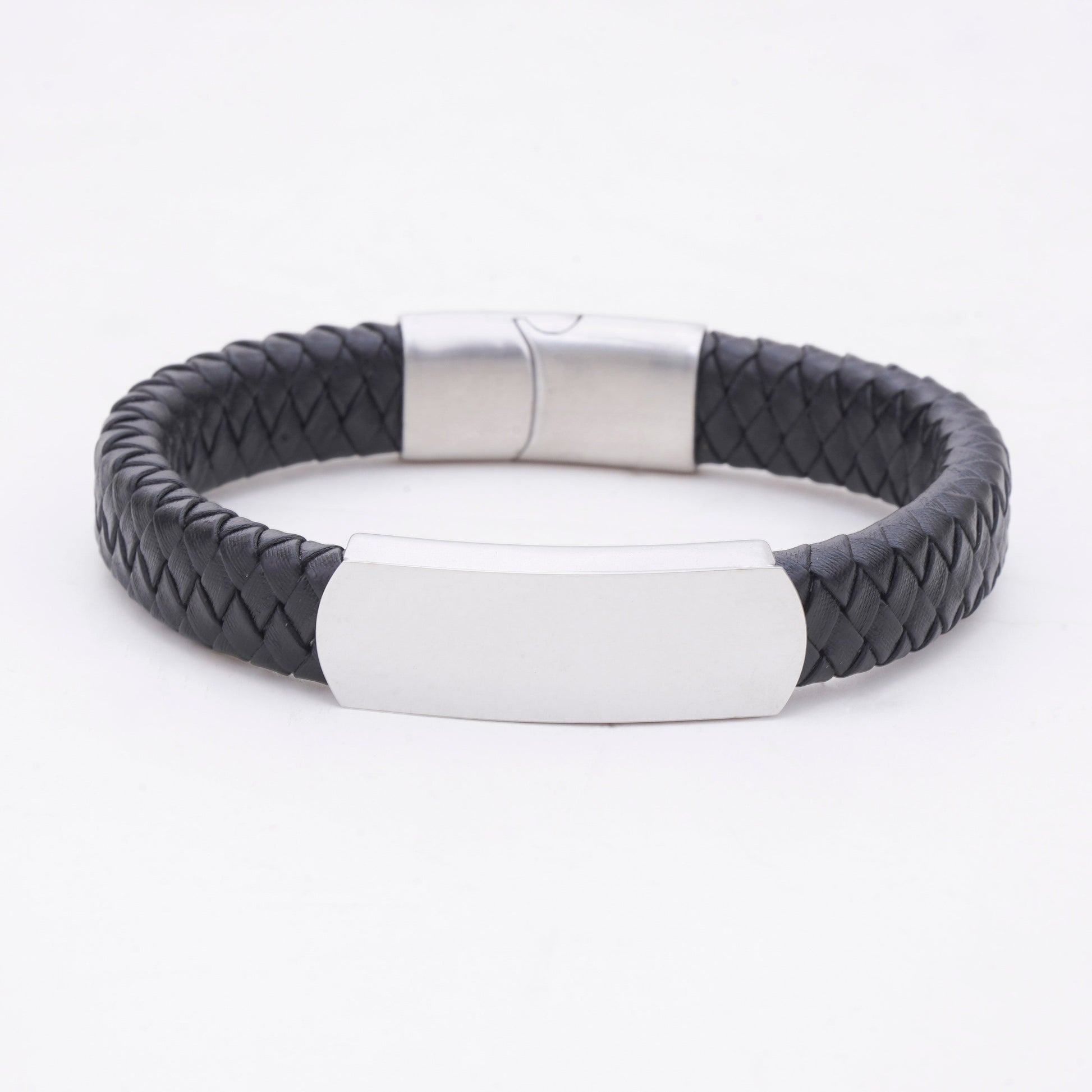 Black braided bracelet with a silver tag on a white background