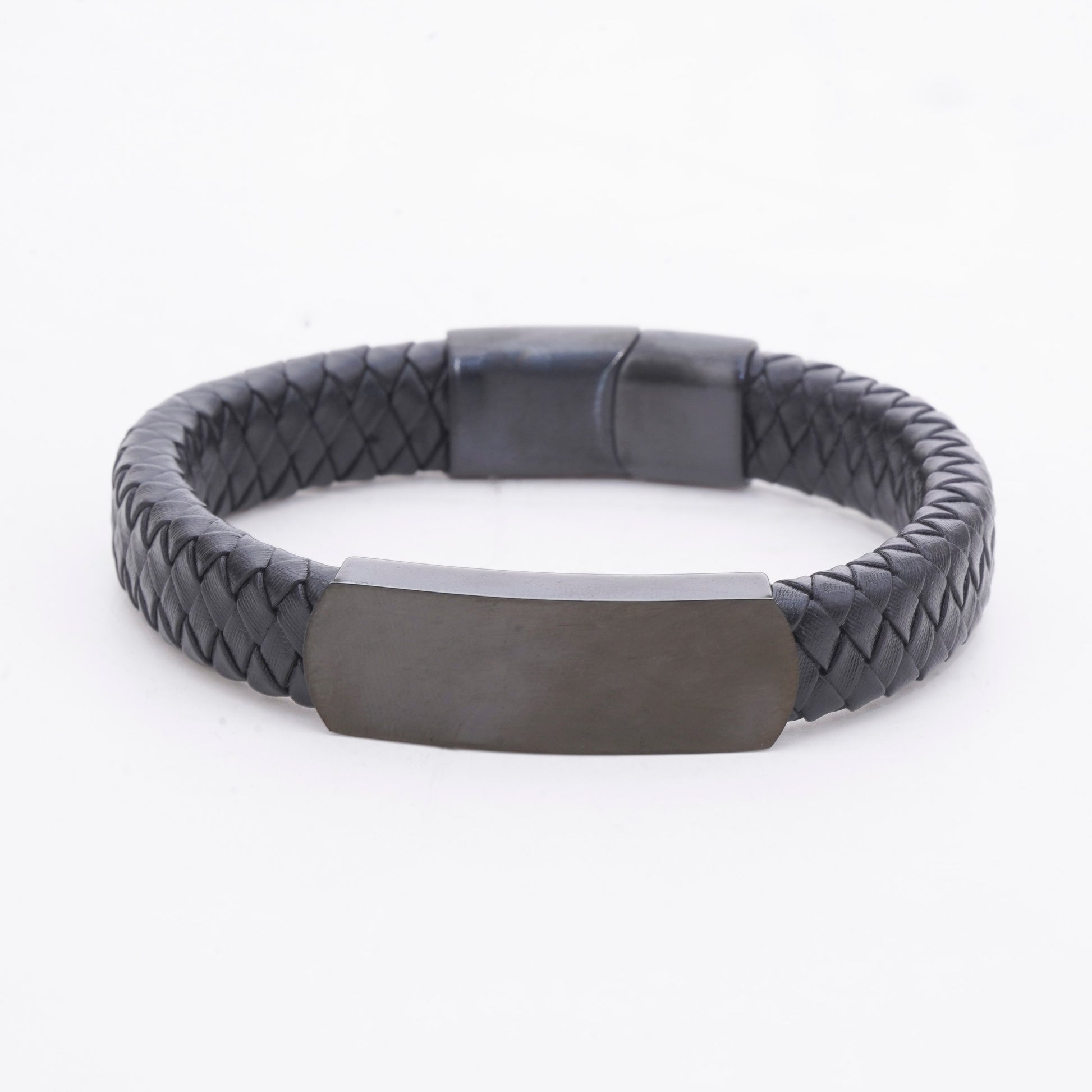 Black braided bracelet with a rectangular metal tag on a white background