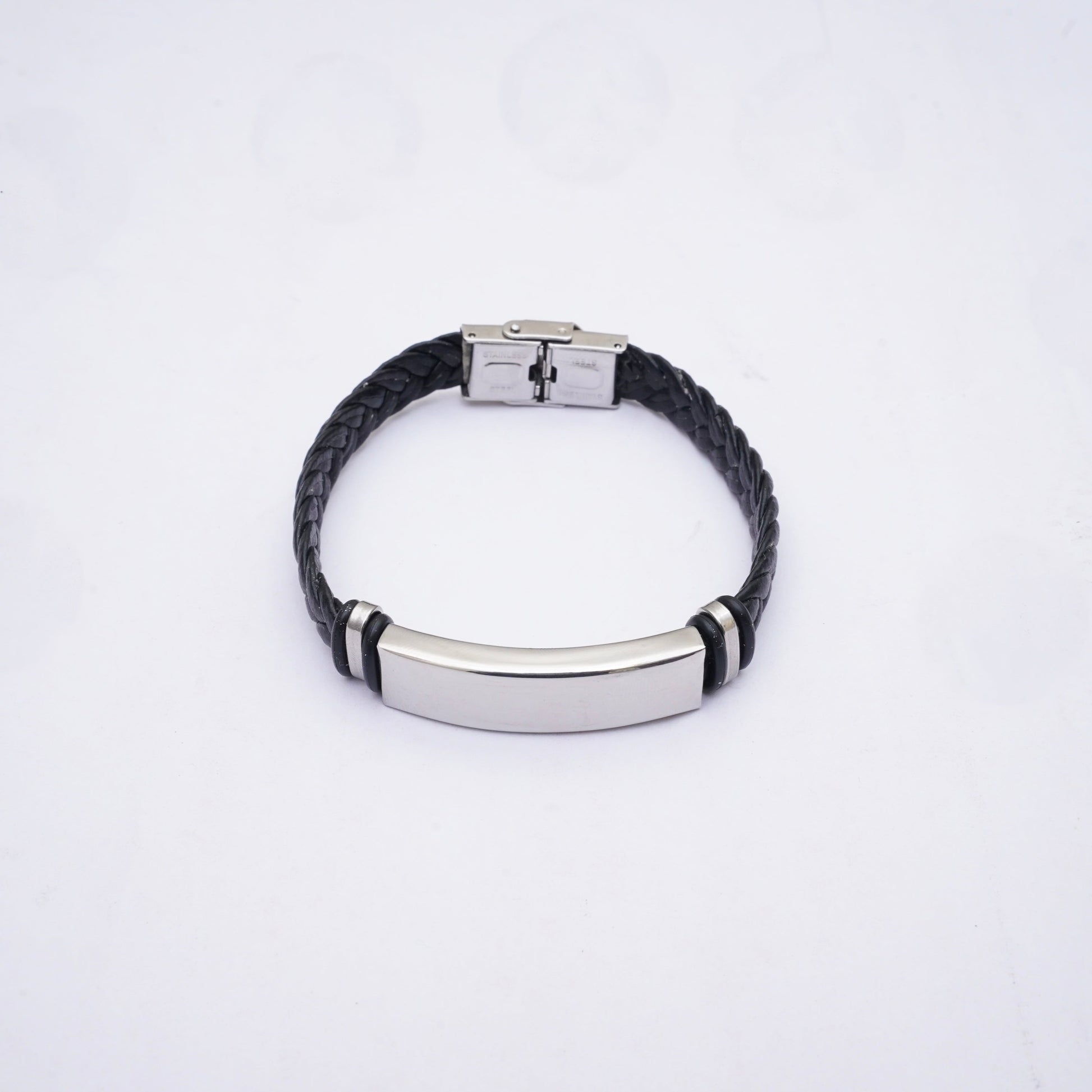 Black braided bracelet with silver clasp on a white background