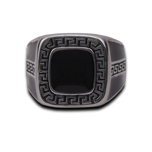 Silver ring with intricate design on a white background